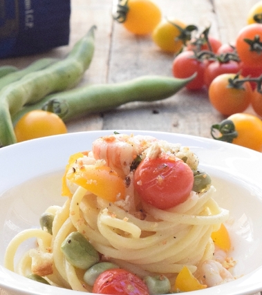 Spaghettone con gamberi fave e pomodorini gialli